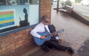 Geoff busking with his blue classical acoustic guitar in Maclean N.S.W. Australia